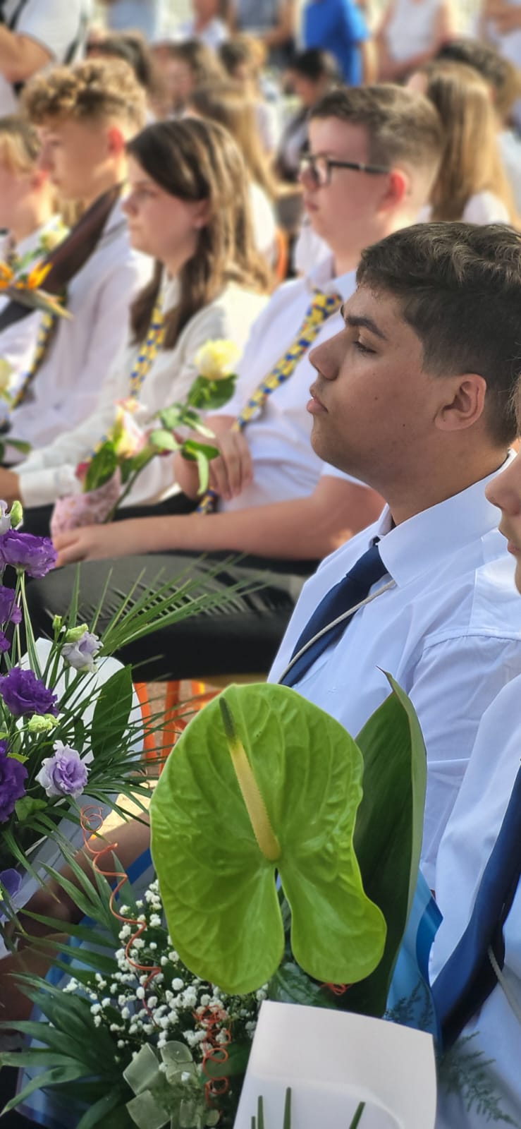 Graduation ceremony crowd with flowers
